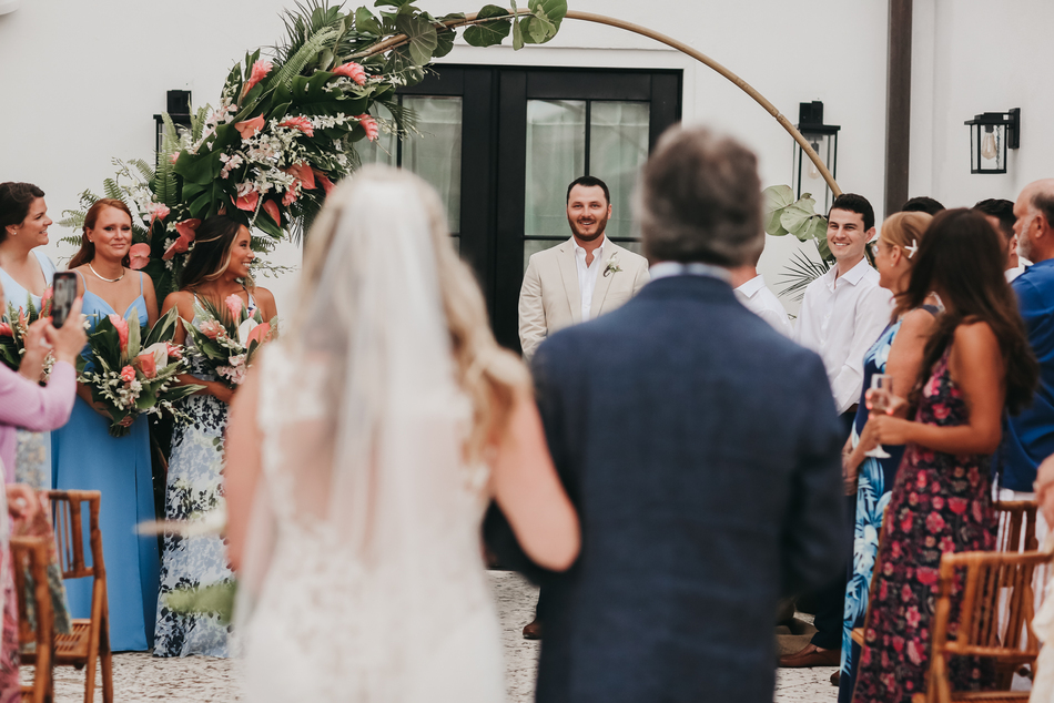 a group of people walking down a aisle