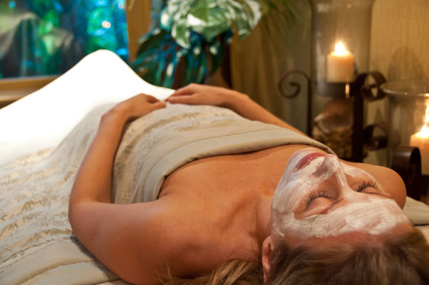 a woman lying down with a mask on her face